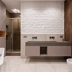 Contemporary bathroom featuring a bathtub, shower, and dual sink vanity with a textured wall.