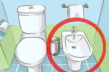 Illustration showing a bidet next to a toilet in a bathroom setting.