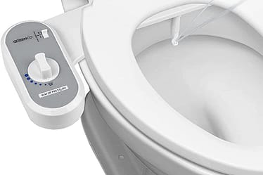 Bidet conversion kit installed on a toilet with a control panel for water pressure.
