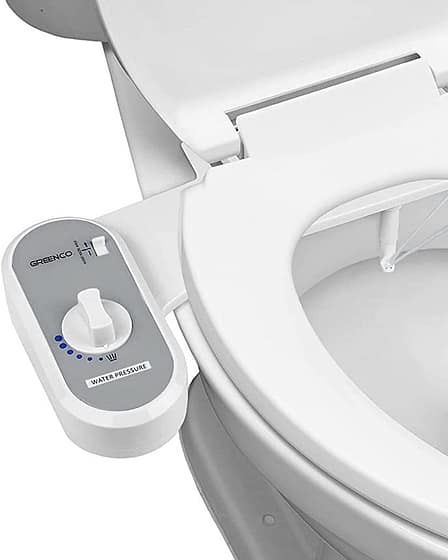 Bidet conversion kit installed on a toilet with a control panel for water pressure.