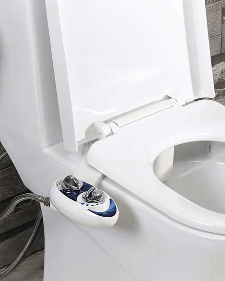 White bidet toilet attachment with control panel on the side, featuring two knobs for water control.