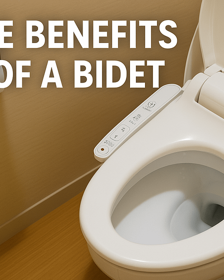 White bidet toilet with a control panel on the side and toilet paper holder in the background.