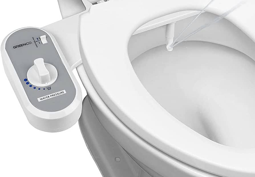 Bidet conversion kit installed on a toilet with a control panel for water pressure.