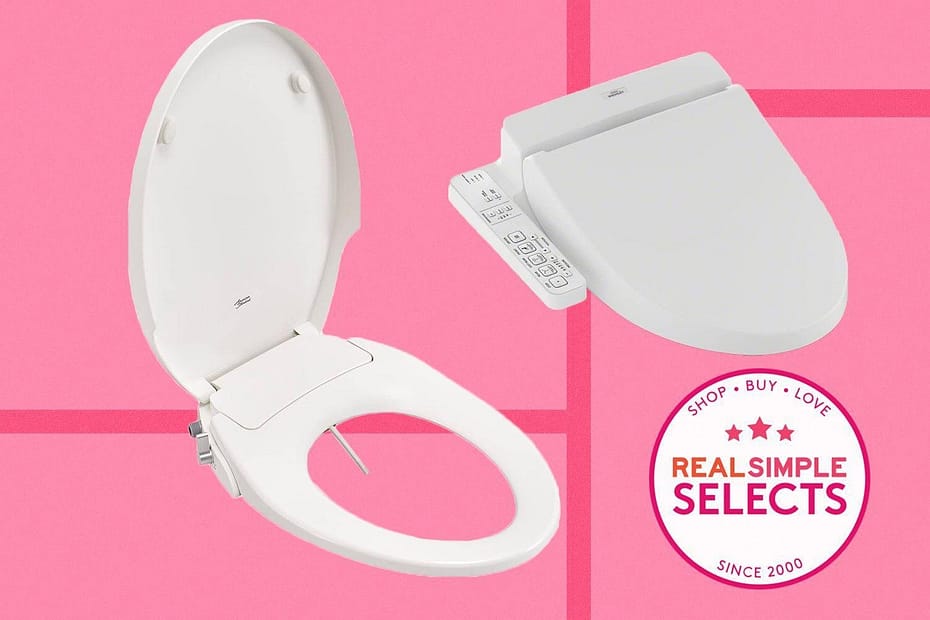 White bidet toilet seat with a remote control on a pink background.