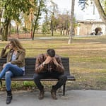 Woman And Man Sitting on Brown Wooden Bench