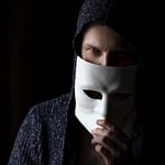 person in black knit cap and gray sweater