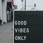 Black sign with white letters displaying the text 'Good Vibes Only'.