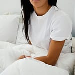 woman sitting on bed