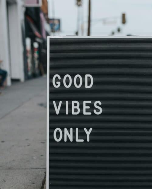 Black sign with white letters displaying the text 'Good Vibes Only'.